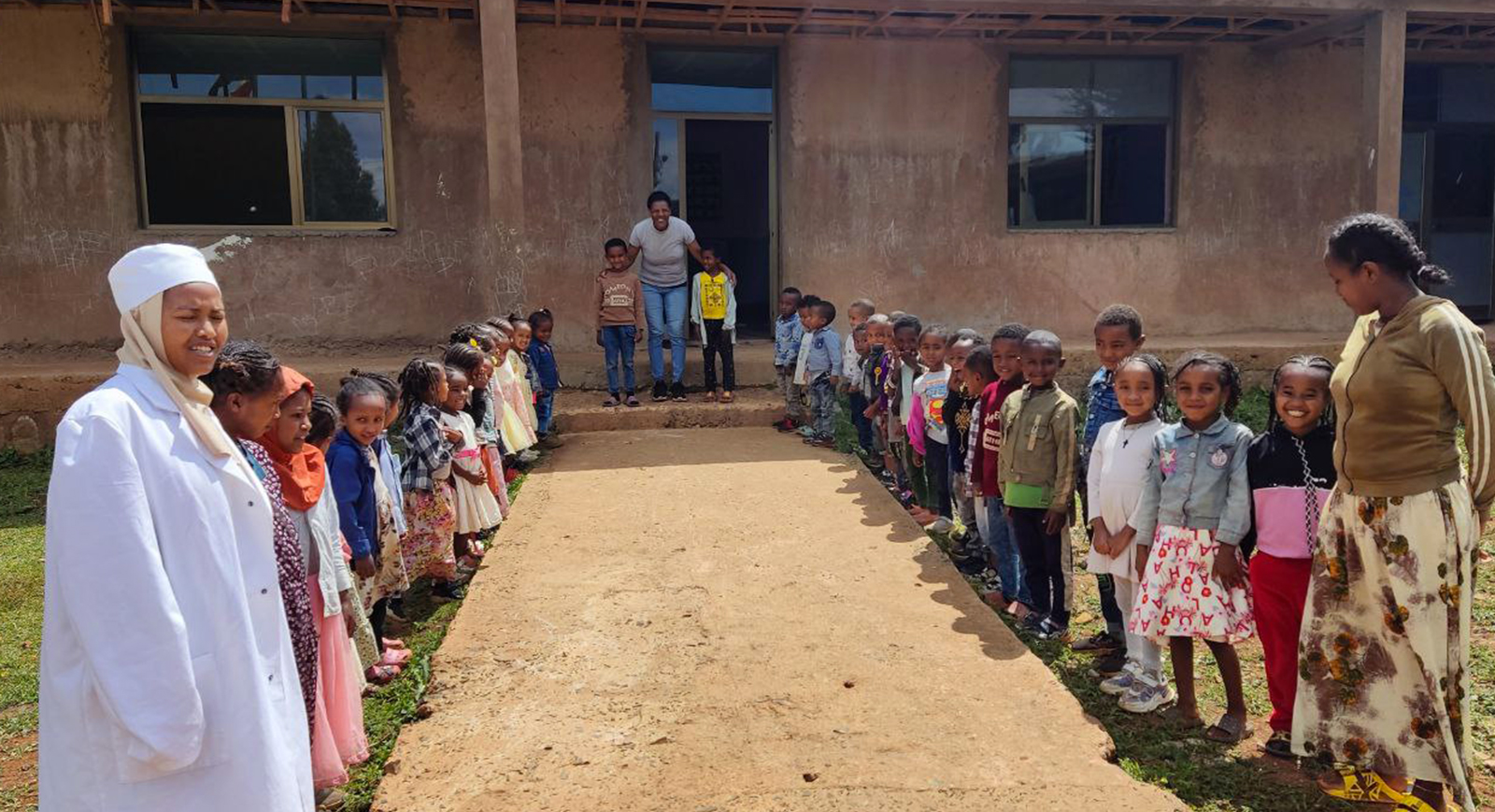 Zewdinesh con bambini e collaboratrici davanti alla scuola in Etiopia